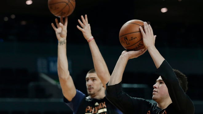 Phoenix Suns' Devin Booker and Alex Len shoot baskets  during practice the day before a game against the Dallas Mavericks at Mexico City Arena on Wednesday, Jan. 11, 2017.