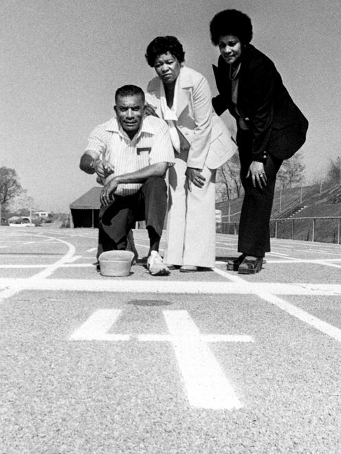 Tennessee State coach Ed Temple, left, explains the markings on the new track, named for two of his former pupils, Mae Faggs, center, and Yvonne Macon Powell. They are here for the dedication festivities for the new track April 7, 1978.