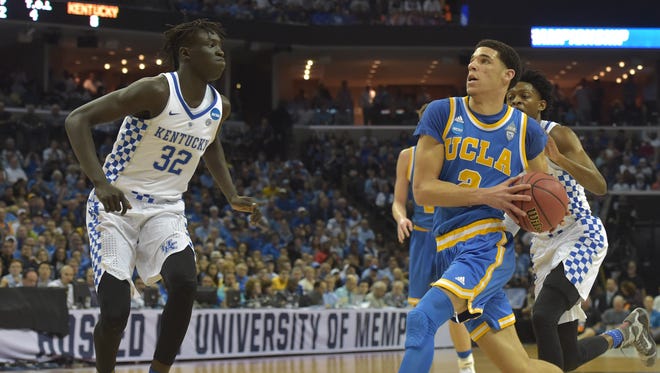 UCLA guard Lonzo Ball drives to the basket against Kentucky forward Wenyen Gabriel (32) during the first half of their game in the Sweet 16 of the NCAA tournament at FedExForum in Memphis.