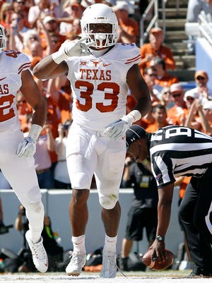 Texas Longhorns running back D'Onta Foreman (33) and tight end Caleb Bluiett (42) celebrate a touchdown in the second quarternagainst the Oklahoma Sooners at Cotton Bowl.