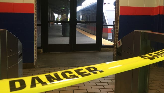 Police tape blocks off a train track at the 69th Street Terminal in Upper Darby, Pa., after a train collision early Tuesday, Aug. 22, 2017, injuring dozens of passengers. A regional rail train crashed into a parked train at the suburban Philadelphia terminal, a regional rail spokeswoman said. (AP Photo/Anthony Izaguirre) ORG XMIT: RPAI201
