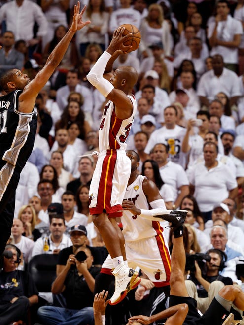 Ray Allen (34) shoots as San Antonio Spurs point guard Tony Parker (9) falls to the ground during the third quarter of Game 6 in the 2013 NBA Finals at American Airlines Arena.