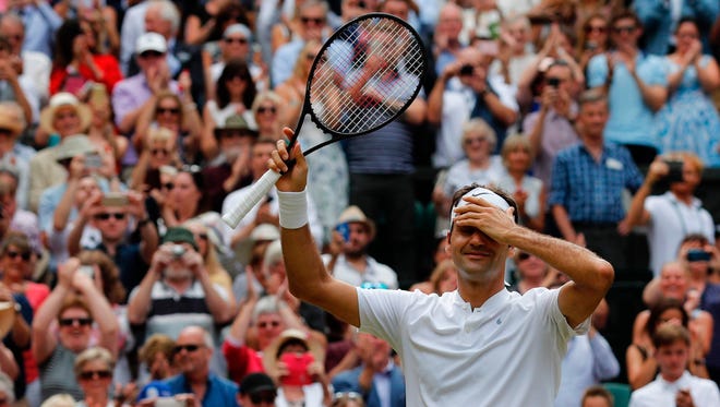 Roger Federer celebrates after winning his eighth Wimbledon title.