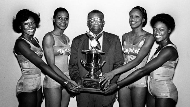 Tigerbelles Ernestine Davis, left, Sheryl Pernell, Coach Ed Temple, Judy Poillin and Chandra Cheeseborough poses with the trophy March 5, 1981 for successful defending their U.S. Indoor track and field championship in New York. This was the school's 28th national track title.