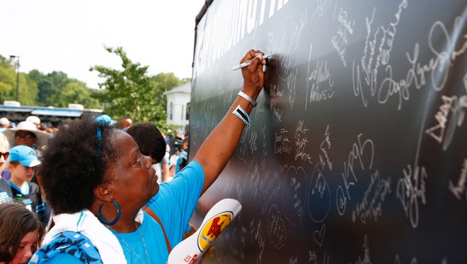 Carolina Panthers fans sign the wall during the Training Camp Kickoff Party  held at Wofford College.
