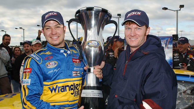 Martin Truex Jr, left, celebrates his 2004 NASCAR Busch Series championship with team co-owner Dale Earnhardt Jr. in Darlington, S.C.