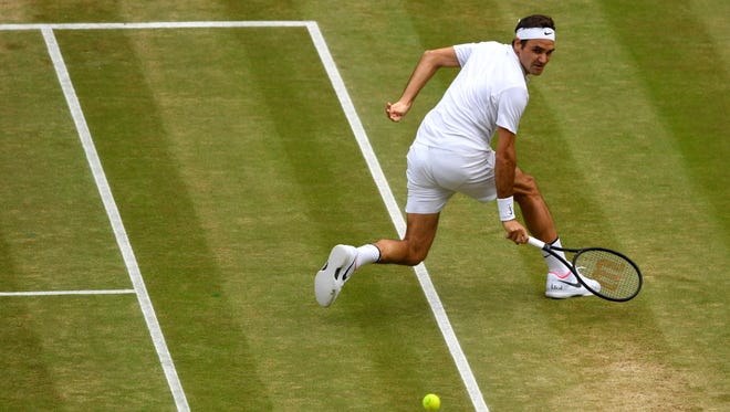 Roger Federer plays a backhand during his match against Martin Cilic.