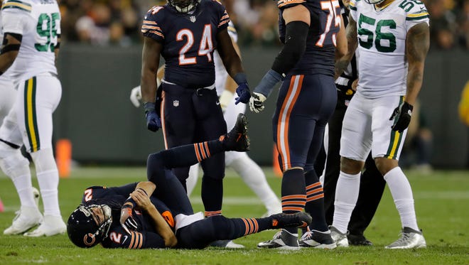 Chicago Bears quarterback Brian Hoyer (2) lies injured on the field during the second quarter against the Green Bay Packers at Lambeau Field.