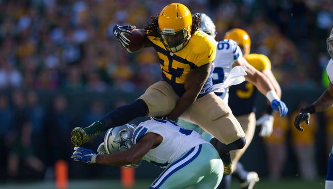 Packers running back Eddie Lacy (27) leaps over Cowboys safety Byron Jones (31) during the first half.
