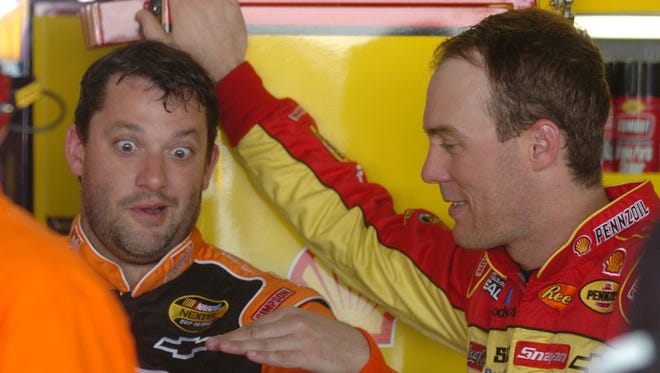 NASCAR drivers Tony Stewart, left, and Kevin Harvick talk in the garage during practice on June 1, 2007 at Dover International Speedway.