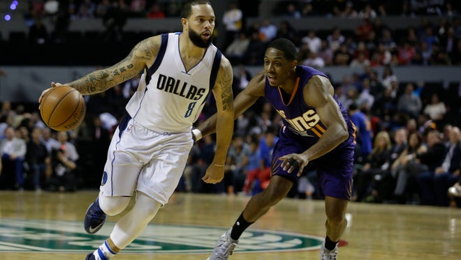 Dallas Mavericks Deron Williams drives the ball past Phoenix Suns Brandon Knight in the first half of their regular-season NBA basketball game in Mexico City, Thursday, Jan. 12, 2017.