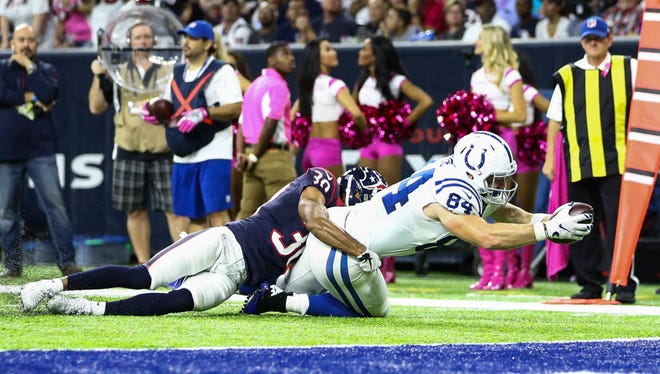 Colts tight end Jack Doyle (84) dives for more yardage after a reception against the Texans.