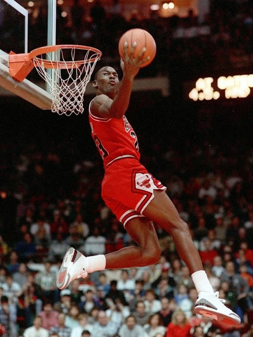 1988: Michael Jordan attempts his "Rock the Cradle" dunk during the 1988 competition in Chicago. He would take home the trophy that year.