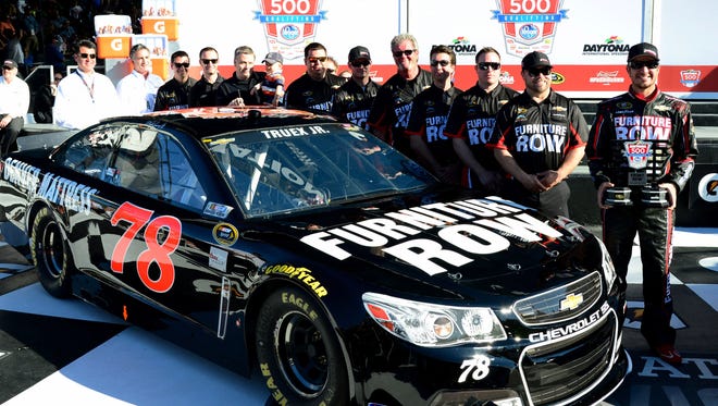 Martin Truex Jr., right, poses with his team after  qualifying second for the 2014 Daytona 500.