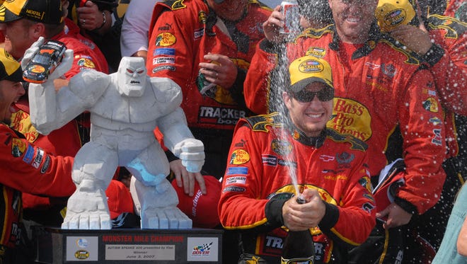 Martin Truex Jr. celebrates with his team next to the Monster Mile trophy after winning his first career Cup race, June 4, 2007 at Dover International Speedway.