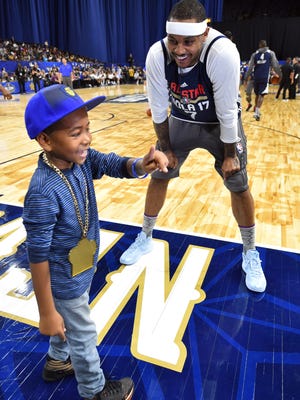 Eastern Conference forward Carmelo Anthony of the New York Knicks (7) talks with a fan during the NBA All-Star Practice at the Mercedes-Benz Superdome.