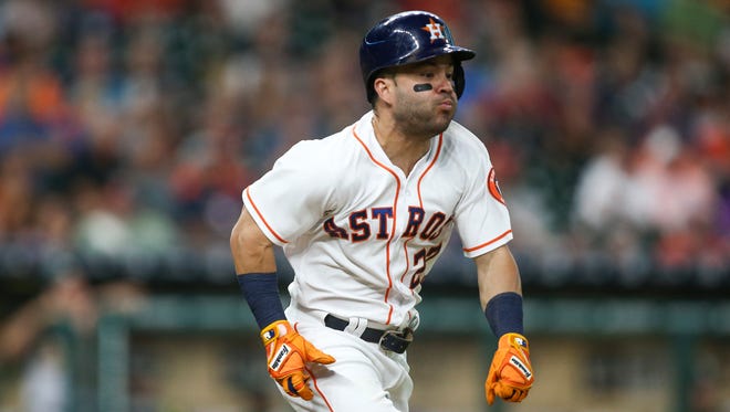 Houston Astros second baseman Jose Altuve hits an infield single during the third inning against the Oakland Athletics at Minute Maid Park.