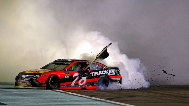Martin Truex Jr. (78) celebrates winning the NASCAR Cup Series championship with a win in the Ford EcoBoost 400 at Homestead-Miami Speedway.