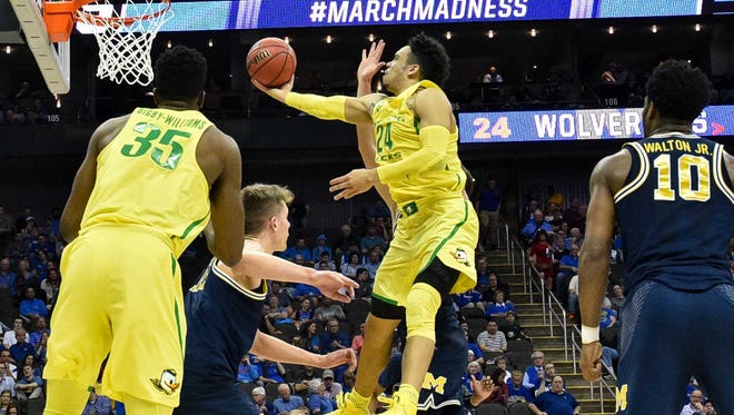 Oregon Ducks forward Dillon Brooks (24) goes up for a shot as Michigan Wolverines guard Derrick Walton Jr. (10) looks on during the first half in the semifinals of the midwest Regional of the 2017 NCAA Tournament at Sprint Center.