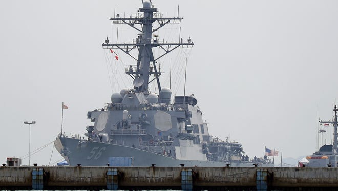 The USS John S. McCain is seen docked at Changi naval base after its accident on Aug. 21, 2017 in Singapore. The USS John S. McCain was docked at Singapore's naval base with "significant damage" to its hull (blocked by berth) after an early morning collision with the oil tanker Alnic MC as vessels from several nations searched Monday for missing U.S. sailors.