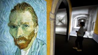 A visitor walks past an image of Van Gogh's "Self-Portrait" during a press event for the world premiere of the "Meet Vincent Van Gogh" exhibit in Beijing on June 15, 2016.