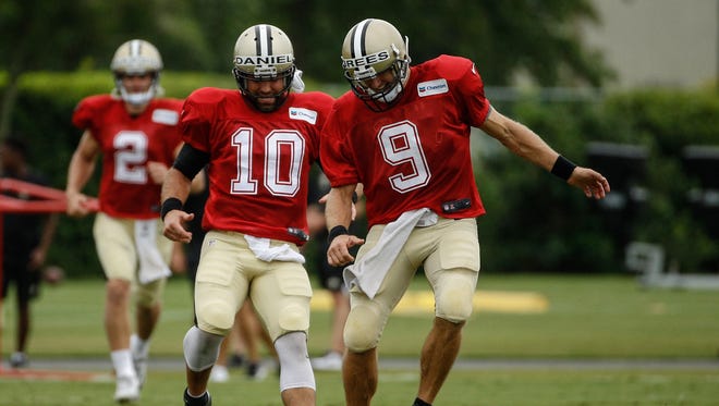 Saints quarterbacks Drew Brees (9) and Chase Daniel (10) go through drills during practice in Metairie, La.