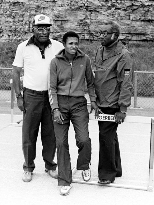 Mattline Render, center, a former Tigerbelle, is back home to run in the Tigerbelle Relays at the Ed Temple track, as a member of the New York Police Athletic League. Her old coach, Ed Temple, left, and her current coach, Connie Ford, right, are with her at the track April 11, 1980.