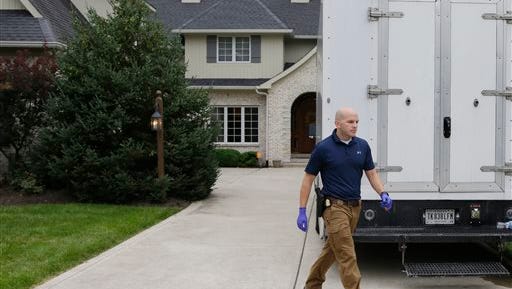 Federal authorities walk outside of the home of Subway restaurant spokesman Jared Fogle, Tuesday, July 7, 2015, in Zionsville, Ind. FBI agents and Indiana State Police have removed electronics from the property. FBI Special agent Wendy Osborne said Tuesday that the FBI was conducting an investigation in the Zionsville area but wouldn't confirm it involved Fogle.