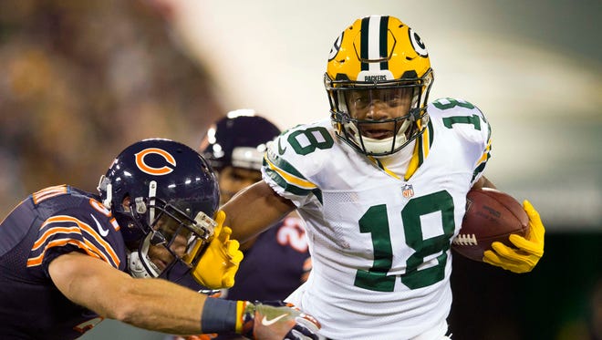 Green Bay Packers wide receiver Randall Cobb (18) stiff arms Chicago Bears defensive back Chris Prosinski (31) after catching a pass during the first quarter at Lambeau Field.