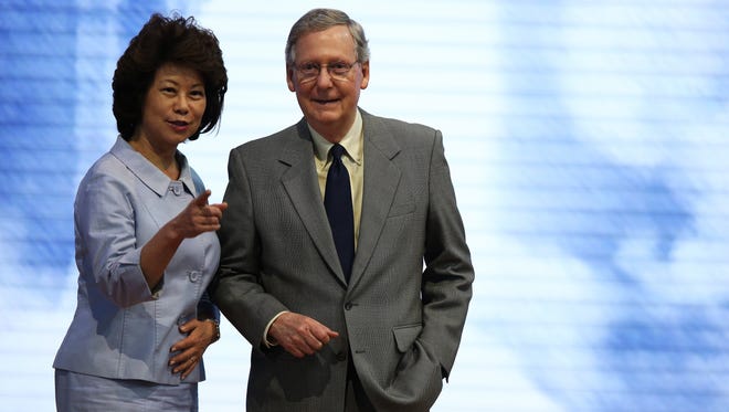McConnell stands on stage with his wife, Elaine Chao, at the Republican National Convention on Aug. 26, 2012, in Tampa, Fla.