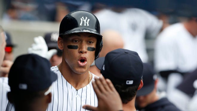 Sept. 20: Aaron Judge, seen celebrating with his teammates, slugs his American League-leading 45th home run in the third inning off Twins right-hander Bartolo Colon.