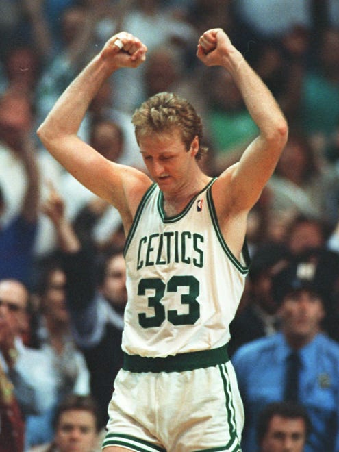 Larry Bird of the Boston Celtics celebrates victory over the Detroit Pistons in Game 5 of the NBA Playoffs at Boston Garden in this May 26, 1987 photo.