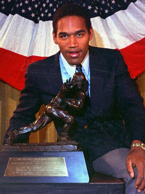 Simpson poses with the Heisman Trophy in 1968.