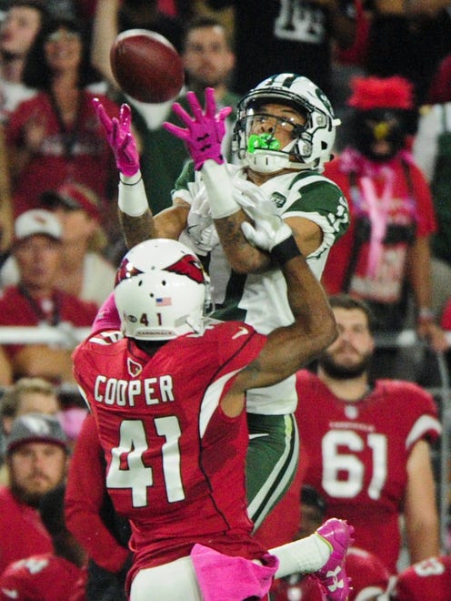 Cardinals cornerback Marcus Cooper (41) breaks up a pass intended for Jets receiver Robby Anderson (11).