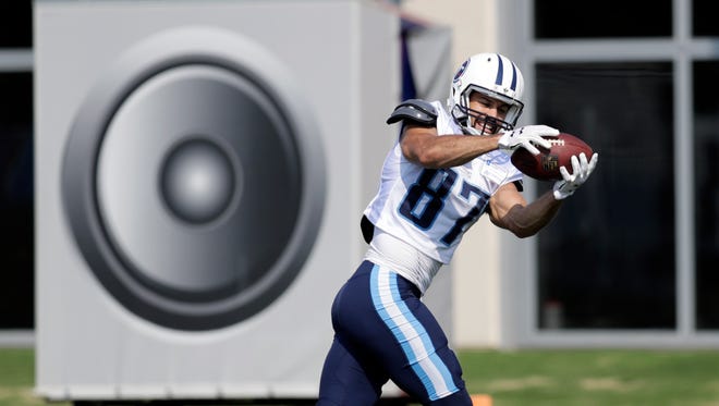 Tennessee Titans wide receiver Eric Decker catches a pass in front of a speaker used to simulate stadium noise during NFL football training camp.