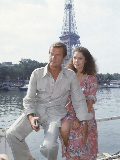 Co-stars Roger Moore, left, and Lois Chiles pose by the Eiffel Tower in Paris, France, Aug. 7, 1978, one week before filming begins for the 11th James Bond film, 'Moonraker.'