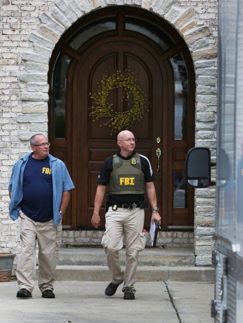 Two FBI agents exit the Zionsville home of Subway spokesperson Jared Fogle in the 4500 block of Woods Edge Drive in Zionsville during a morning-long investigation in FogleÕs home in the Austin Oaks subdivision on Tuesday morning, July 7, 2015. FogleÕs attorney says Fogle is cooperating in the probe and has not been detained or arrested. Russell Taylor, 43, who had been the Jared Foundation executive director, faces federal charges after being arrested in late April on seven counts of production of child pornography and one count of possession of child pornography.