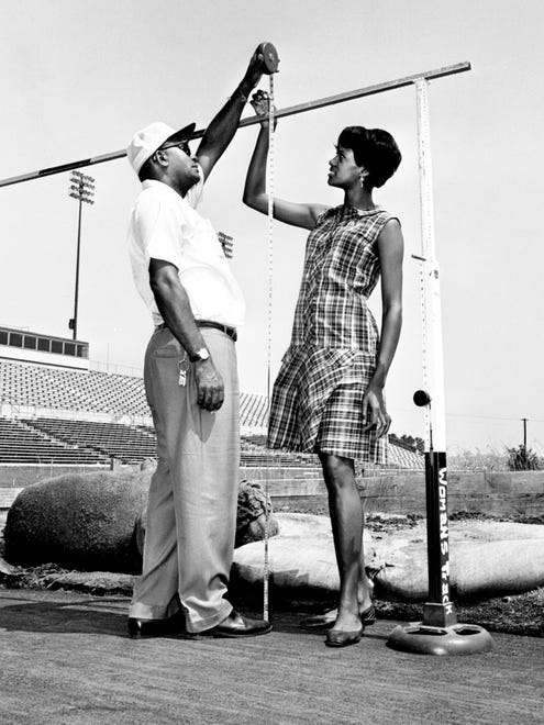 Eleanor Montgomery, right, one of the world's best high jumpers, and coach Ed Temple, measure the bar at six feet as they inspect the renovated jumping area at Tennessee State A&I stadium June 5, 1968.