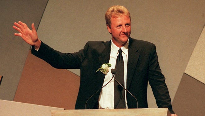Basketball Hall of Fame inductee Larry Bird waves to the crowd during a standing ovation, on stage at the hall of fame induction ceremony held at the Springfield, Mass., civic center, Friday, Oct. 2, 1998.