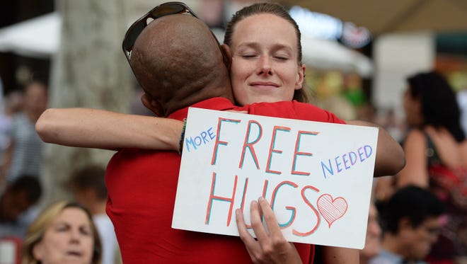 People give out free hugs on the Las Ramblas boulevard in Barcelona on Aug. 19, 2017, two days after a van plowed into the crowd, killing 13 persons and injuring over 100.