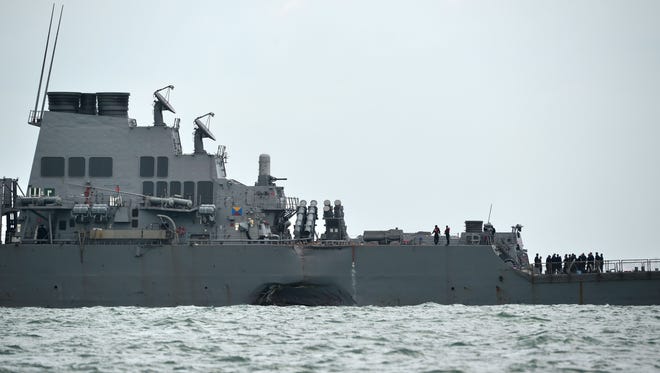 A general view shows the guided-missile destroyer USS John S. McCain with a hole on its left portside after a collision with oil tanker, outside Changi naval base in Singapore Aug. 21, 2017.
Ten US sailors were missing and five injured early on August 21 after their destroyer collided with a tanker east of Singapore, the second accident involving an American warship in two months. RAHMANROSLAN RAHMAN/AFP/Getty Images ORIG FILE ID: AFP_RQ0AN