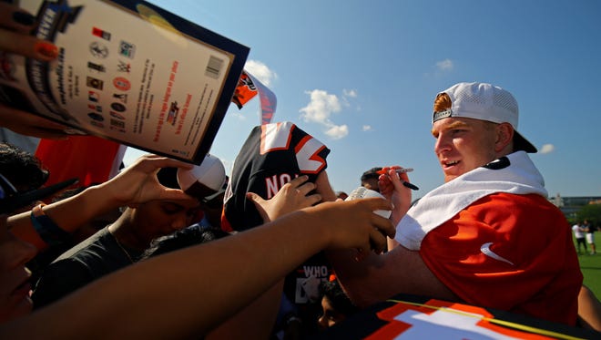 Bengals quarterback Andy Dalton signs autographs after practice in Cincinnati.