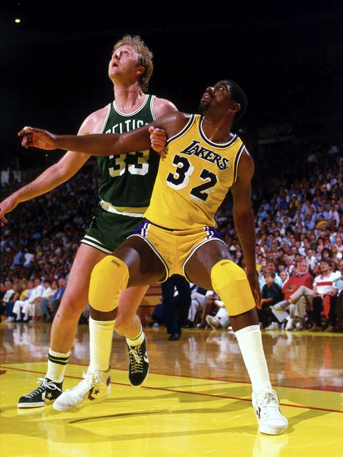Magic Johnson #32 of the Los Angeles Lakers battles for position against Larry Bird #33 of the Boston Celtics during a game in 1984 at The Great Western Forum in Inglewood, California.