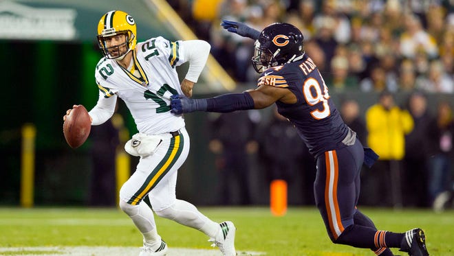 Chicago Bears linebacker Leonard Floyd (94) tries to tackle Green Bay Packers quarterback Aaron Rodgers (12) during the first quarter at Lambeau Field.