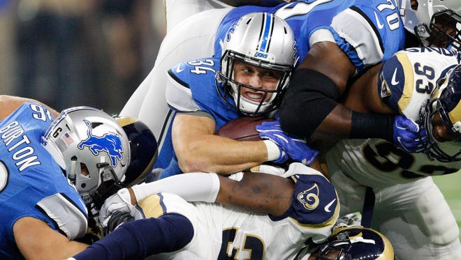 Detroit Lions fullback Zach Zenner (34)  gets tackled against the Los Angeles Rams during the first quarter at Ford Field.