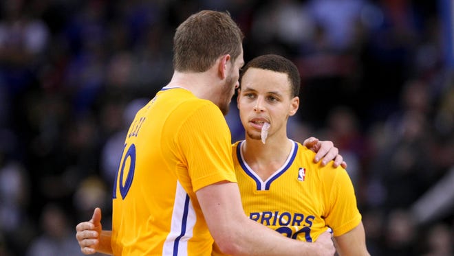 2013: Golden State Warriors power forward David Lee hugs point guard Stephen Curry.