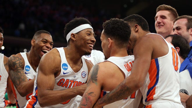 The Florida men's basketball team celebrates their dramatic victory over Wisconsin in the Sweet 16 of the NCAA tournament at Madison Square Garden in New York.