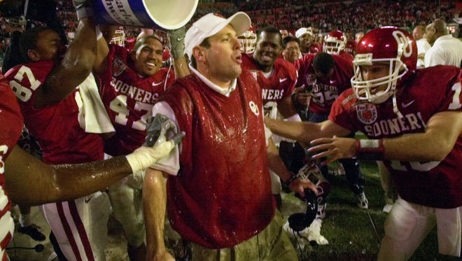 Oklahoma coach Bob Stoops reacts after getting drenched by his players after the Sooners beat Florida State to win the 2000 national championship in the Orange Bowl.
