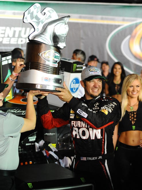 Martin Truex Jr. (78) celebrates with his team after winning the 2017 Quaker State 400 at Kentucky Speedway, his third win of the season.