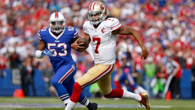 San Francisco 49ers quarterback Colin Kaepernick (7) runs the ball during the first half against the Buffalo Bills at New Era Field.